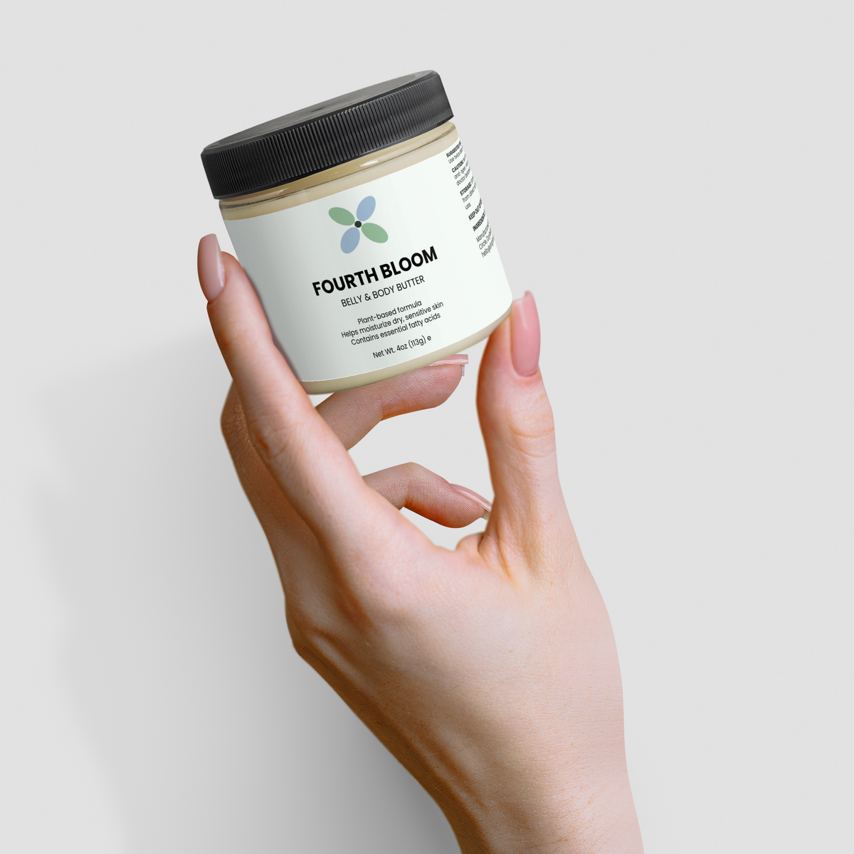 Fourth Bloom Belly & Body Butter jar, 4 oz organic shea, angled in hand