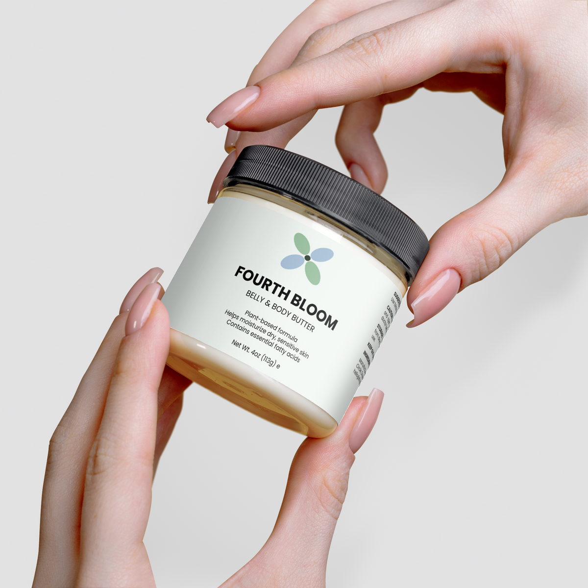 Fourth Bloom Belly & Body Butter jar, 4 oz organic shea, held in both hands