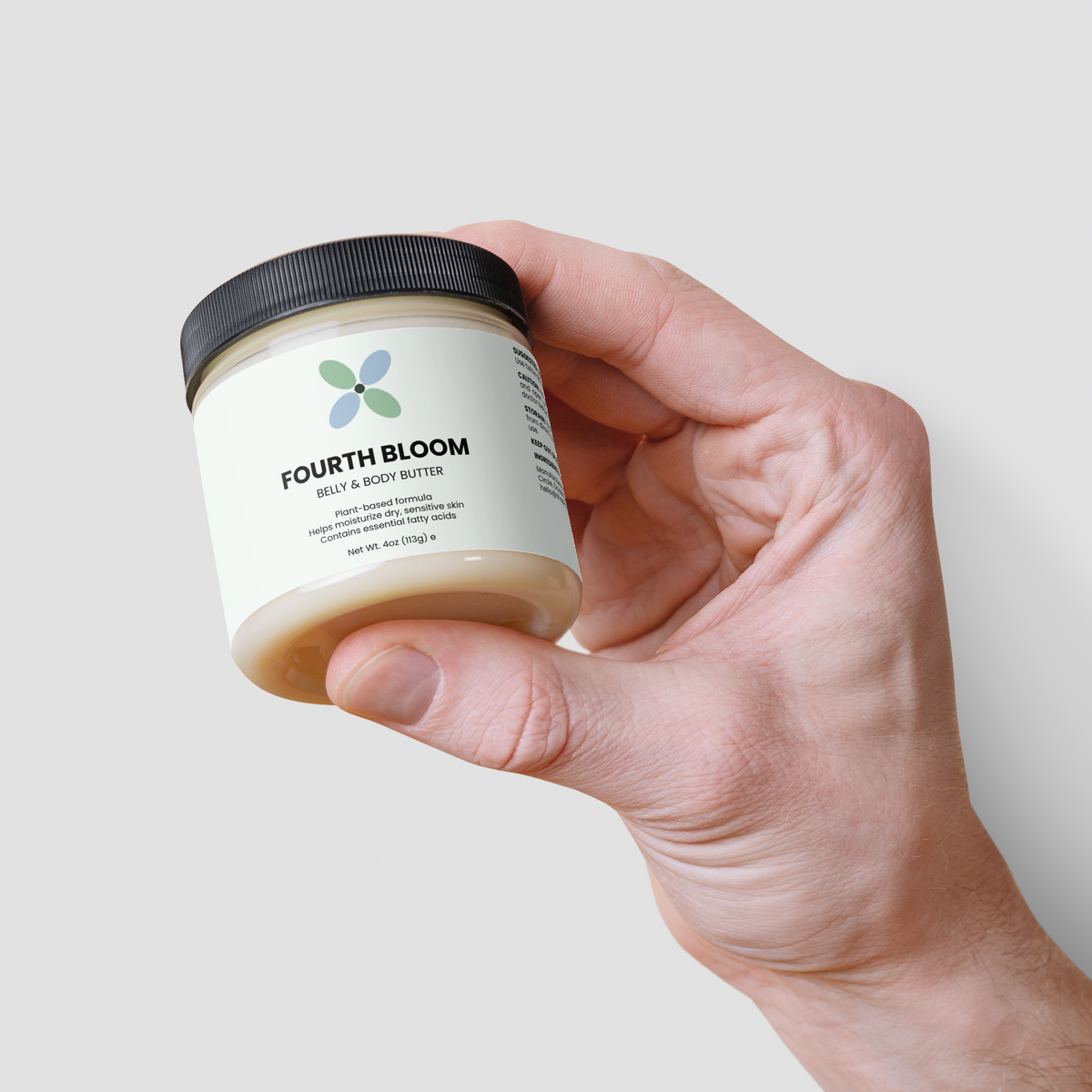 Fourth Bloom Belly & Body Butter jar, 4 oz organic shea, held in hand