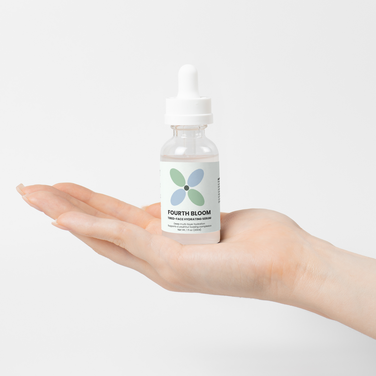 Fourth Bloom Tired-Face Hydrating Serum bottle, 1 fl oz, in an open palm