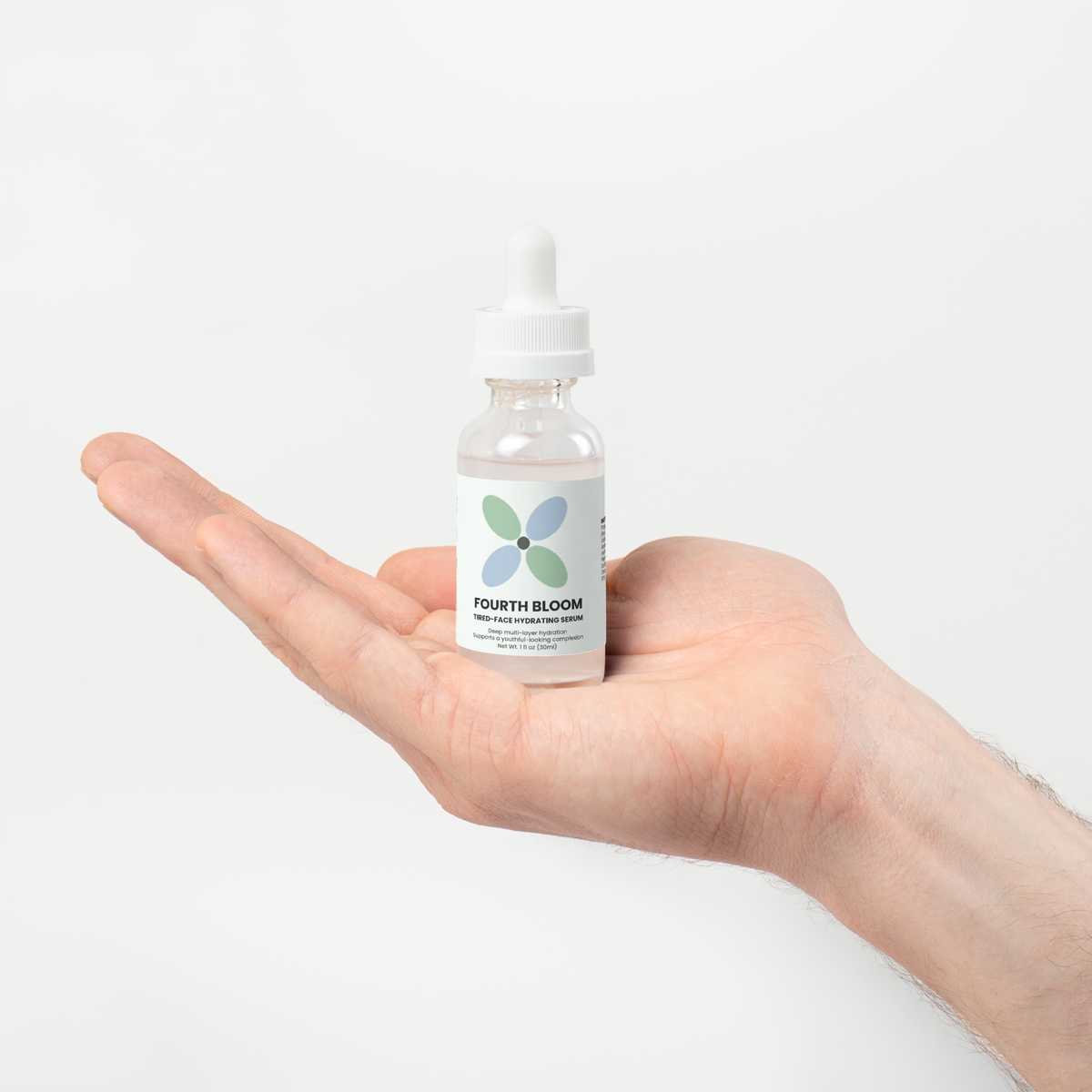 Fourth Bloom Tired-Face Hydrating Serum bottle, 1 fl oz, resting in palm